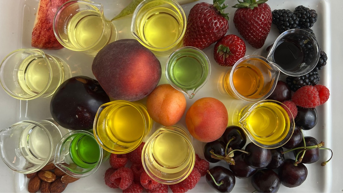 platter of fresh fruit and carrier oils in glass beakers