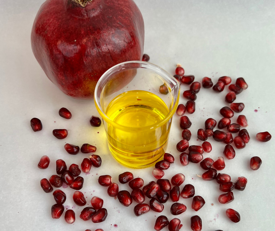 Pomegranate Seed Oil Pomegranate Seed oil in beaker with pomegranate seeds