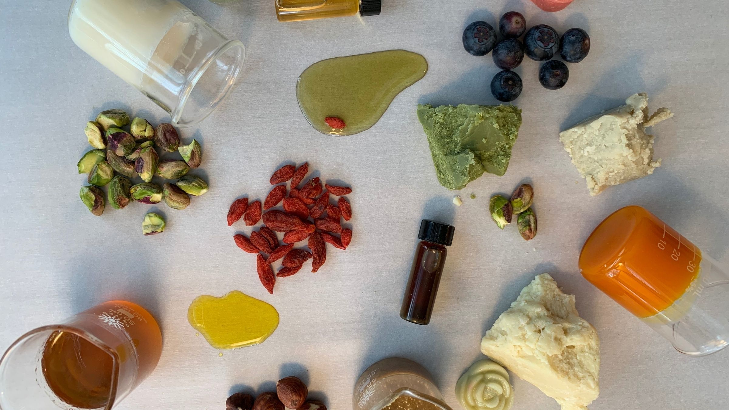 Carrier Oils & Butters assorted seeds, berries, plant butters, oils, and bottles