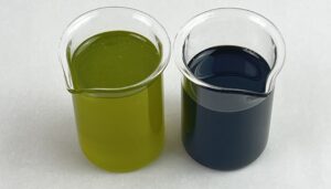 two versions of tamanu oil in glass beaker
